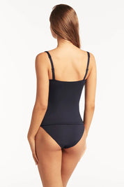 A model wearing the Twist Front Multifit Singlet Top in colour Nightsky (Blue), from the back