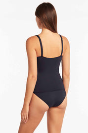 A model wearing the Cross Front Multifit Singlet Top in colour Nightsky (Blue), from the back