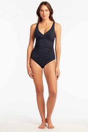 A model wearing the Cross Front Multifit Singlet Top in colour Nightsky (Blue), from the front, showing the whole outfit