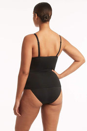 A model wearing the Twist Front DD/E Cup Tankini in colour Black (Black), from the back