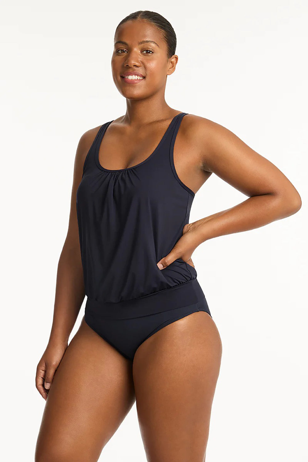 A model wearing the Blouson Tank Multifit Singlet Top in colour Nightsky (Blue), from the front, cropped image