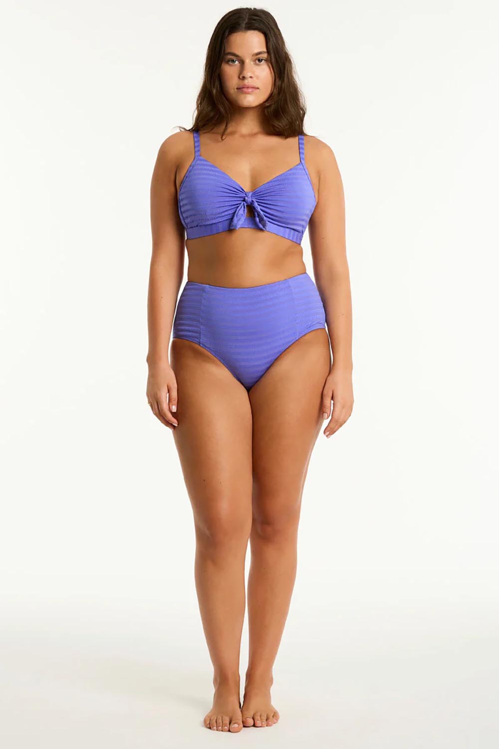 A model wearing the Panelled High Waist Pant in colour Iris (Blue), from the front, showing the whole outfit