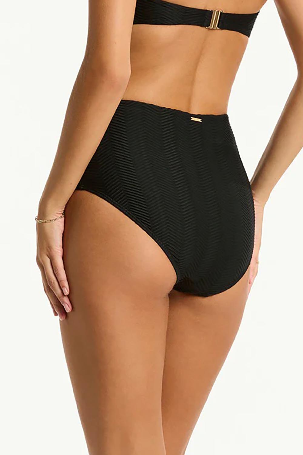 A model wearing the Panelled High Waist Pant in colour Black (Black), from the back