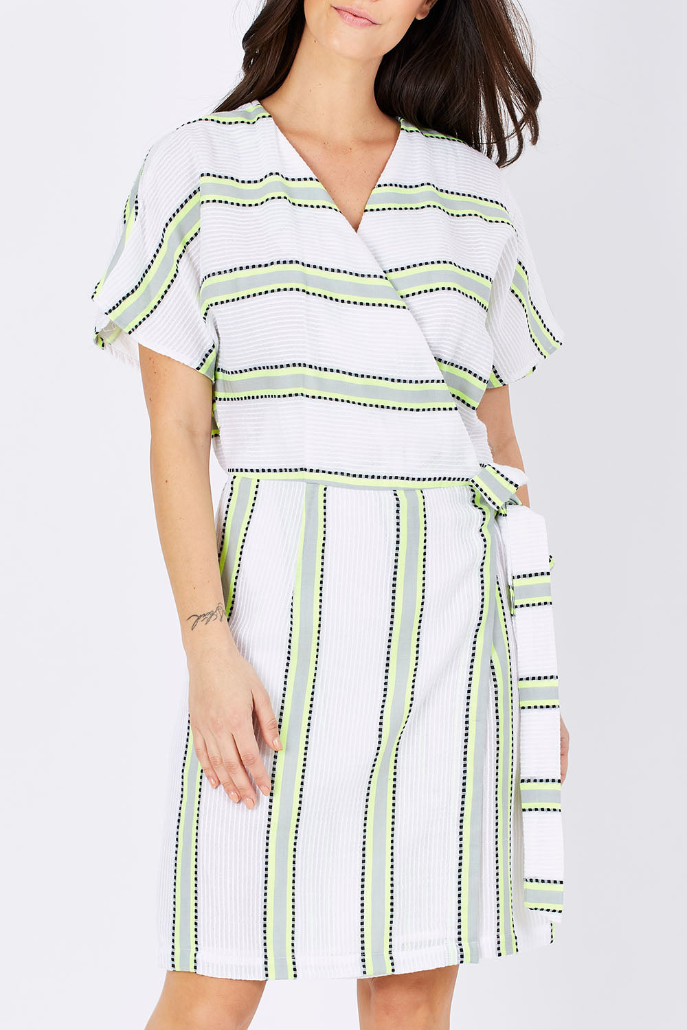 Model Georgia wearing size S of the Dawn Wrap Dress in colour NeonDawn (White), from the front, cropped image