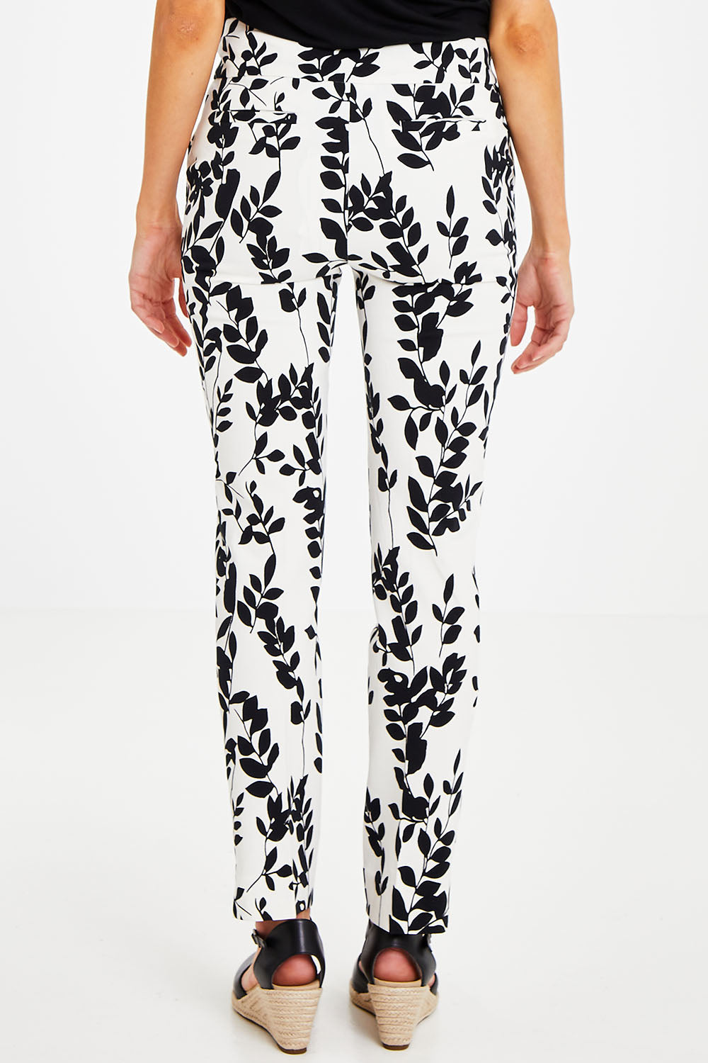 Model Courtney wearing size 8 of the Ankle Pull On Pants With Pockets in colour Floral (Black), from the back
