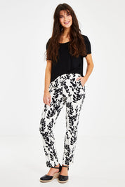 Model Courtney wearing size 8 of the Ankle Pull On Pants With Pockets in colour Floral (Black), from the front, showing the whole outfit