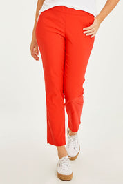 Model Georgia wearing size 10 of the Ankle Pull On Pants With Pockets in colour Tomatored (Red), from the front, cropped image