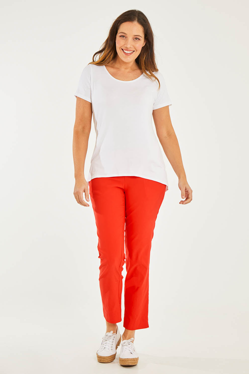 Model Georgia wearing size 10 of the Ankle Pull On Pants With Pockets in colour Tomatored (Red), from the front, showing the whole outfit