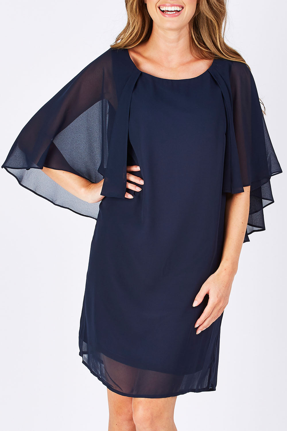 Model Emma wearing size 10 of the Butterfly Chiffon Dress in colour Navy (Blue), from the front, cropped image