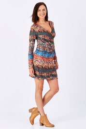 Model Perrie wearing the Avelina Dress in colour Darkorange, from the front, showing the whole outfit