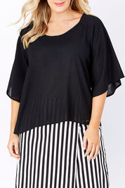Model Jess wearing the Farreras Blouse in colour Black (Black), from the front, cropped image
