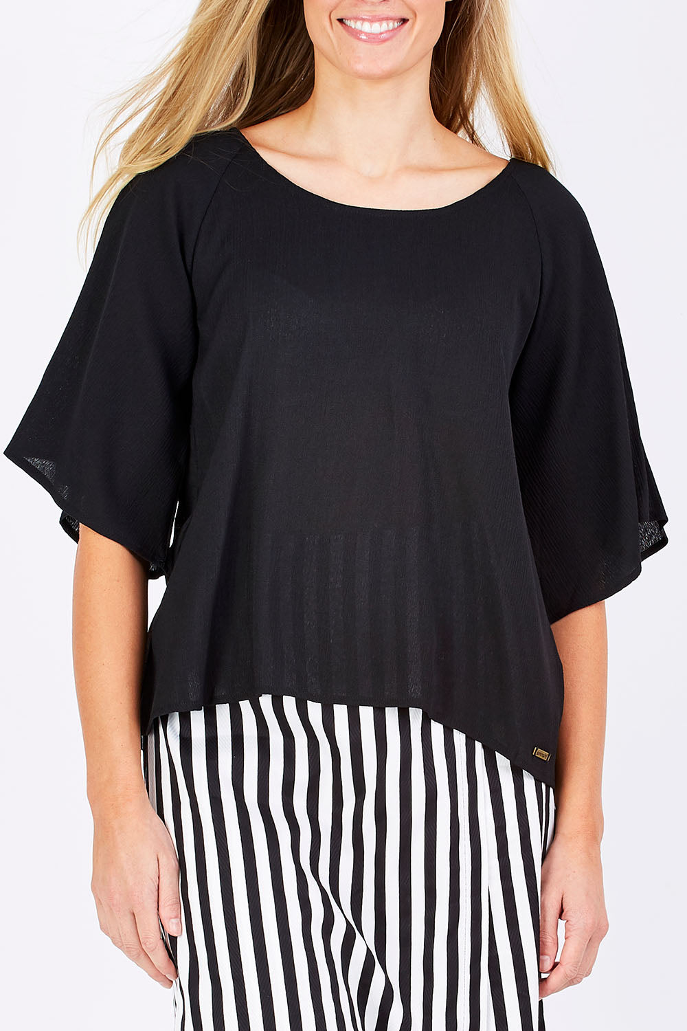 Model Maddy wearing the Farreras Blouse in colour Black (Black), from the front, cropped image