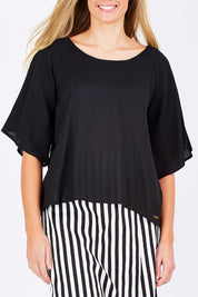 Model Maddy wearing the Farreras Blouse in colour Black (Black), from the front, cropped image