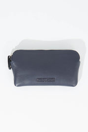 A model wearing size OneSize of the Lucy Leather Coin Pouch in colour Navy (Blue), from the front, showing the whole outfit