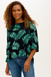 A model wearing the Casey Batik Top in colour Blkgreen (Black), from the front, cropped image