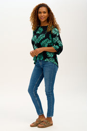 A model wearing the Casey Batik Top in colour Blkgreen (Black), from the front, showing the whole outfit
