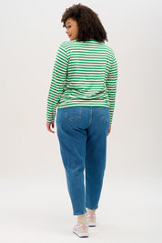 A model wearing the Brunswick Jersey Top in colour Greenwht (Green), from the back