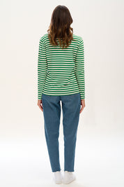 A model wearing the Brunswick Jersey Top in colour Greenwht (Green), from the back