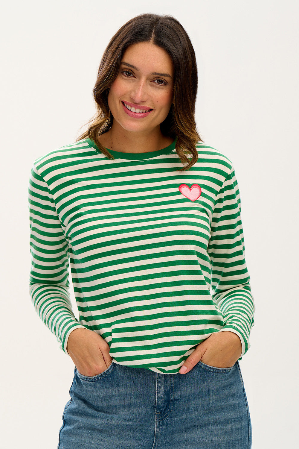 A model wearing the Brunswick Jersey Top in colour Greenwht (Green), from the front, cropped image