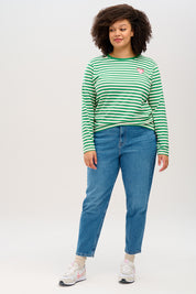 A model wearing the Brunswick Jersey Top in colour Greenwht (Green), from the front, showing the whole outfit