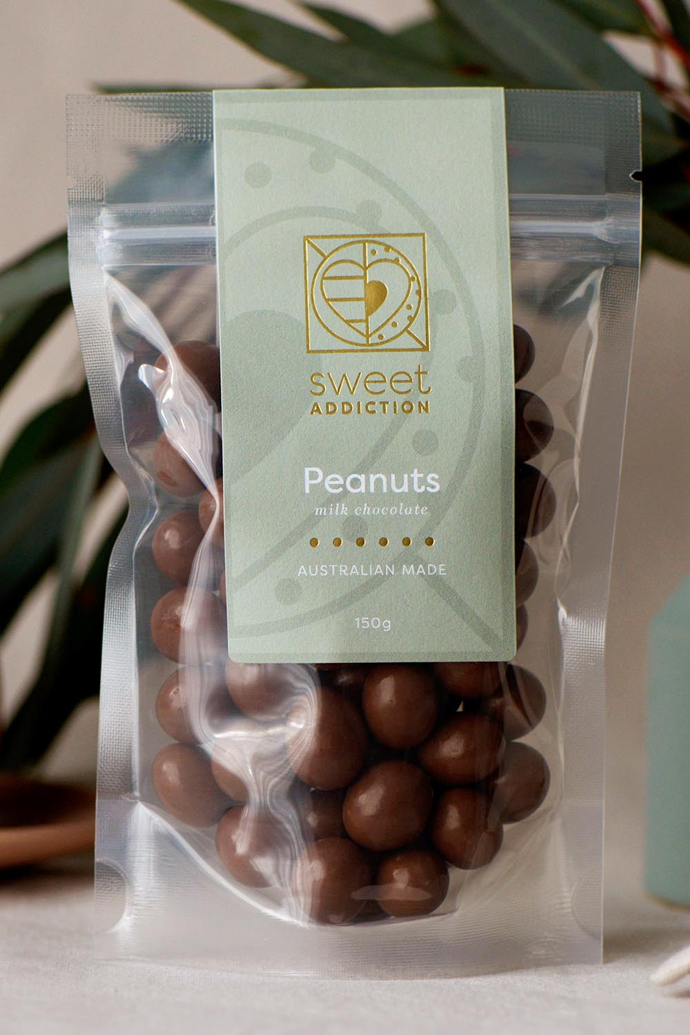 Product shot of the 150g Milk Chocolate Peanuts - Milkpeanuts in colour Milkpeanuts, from the front