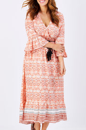 Model Laura wearing size M of the Aurora Dress in colour Wanderer, from the front, cropped image