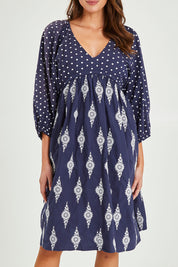 Model Madeline wearing size S of the Gaia Dress in colour Navy (Blue), from the front, cropped image