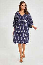 Model Madeline wearing size S of the Gaia Dress in colour Navy (Blue), from the front, showing the whole outfit