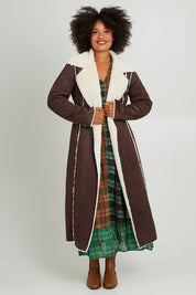 Model Olivia wearing size S of the Sterling Coat in colour Chocolate, from the front, showing the whole outfit