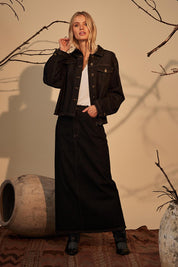 A model wearing the Macey Skirt in colour Blackwash (Black), from the front, showing the whole outfit