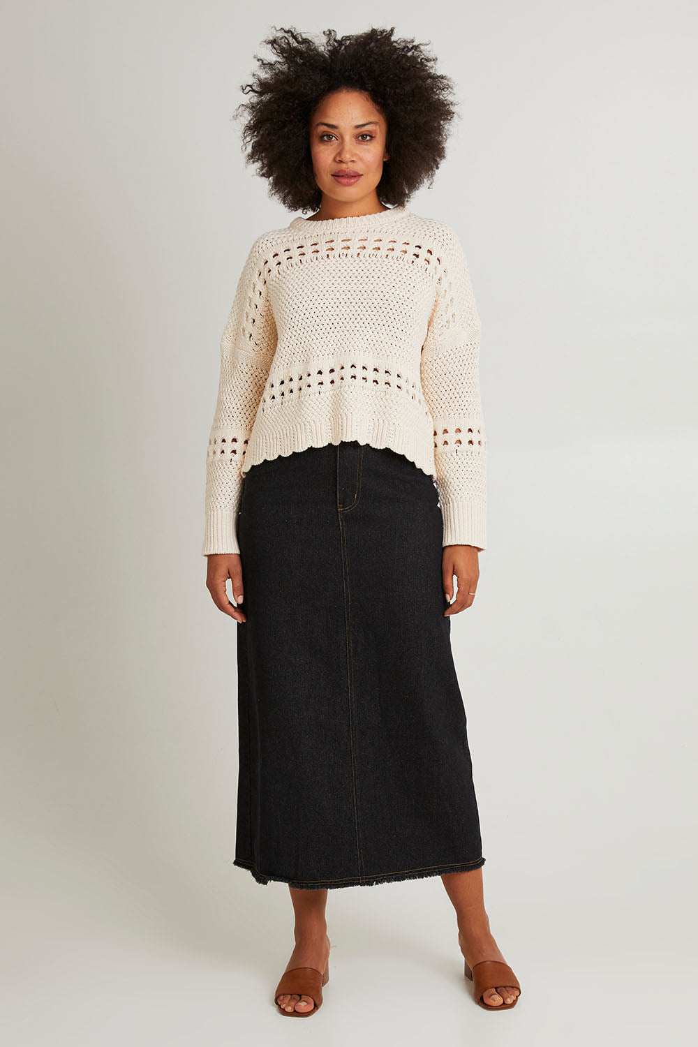 Model Olivia wearing size S of the Macey Skirt in colour Blackwash (Black), from the front, showing the whole outfit