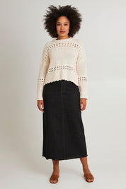 Model Olivia wearing size S of the Macey Skirt in colour Blackwash (Black), from the front, showing the whole outfit