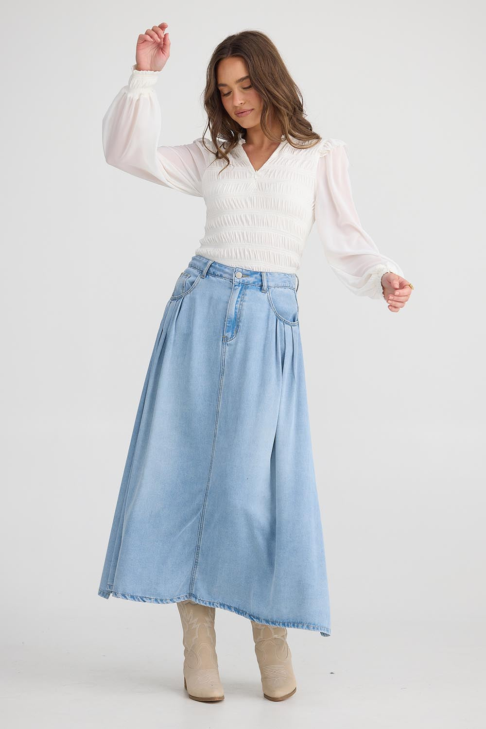A model wearing the Austin Skirt in colour Lightblue (Blue), from the front, showing the whole outfit