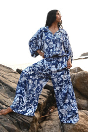 A model wearing the Freedom Pant in colour Celestialb (Blue), from the front, showing the whole outfit