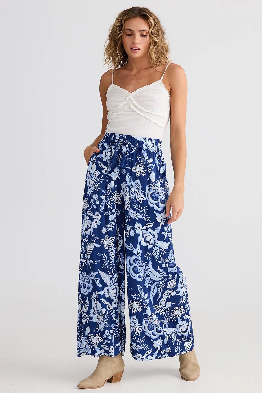 A model wearing the Freedom Pant in colour Celestialb (Blue), from the front, showing the whole outfit