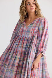 A model wearing the Winnie Cotton Mini Dress in colour Picnicchec (Pink), from the front, cropped image