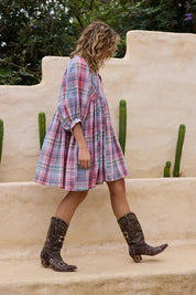 A model wearing the Winnie Cotton Mini Dress in colour Picnicchec (Pink), from the front, showing the whole outfit