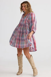 A model wearing the Winnie Cotton Mini Dress in colour Picnicchec (Pink), from the front, showing the whole outfit