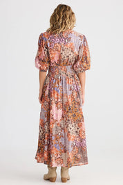 A model wearing the Halo Cotton Dress in colour Dreamweav (Pink), from the back
