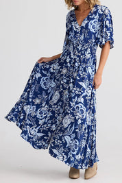 A model wearing the Harlow Dress in colour Celestial (Blue), from the front, cropped image