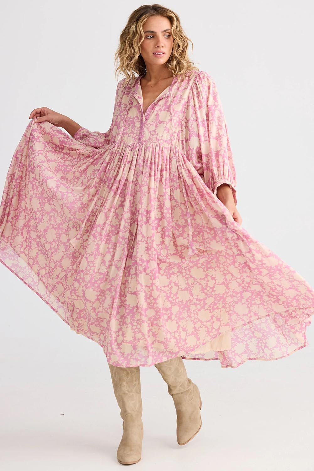 A model wearing the Wisteria Cotton Dress in colour Meadow (Pink), from the front, showing the whole outfit