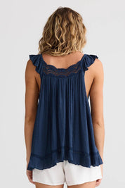 A model wearing the Exhale Cami in colour Navy (Blue), from the back
