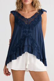 A model wearing the Exhale Cami in colour Navy (Blue), from the front, cropped image
