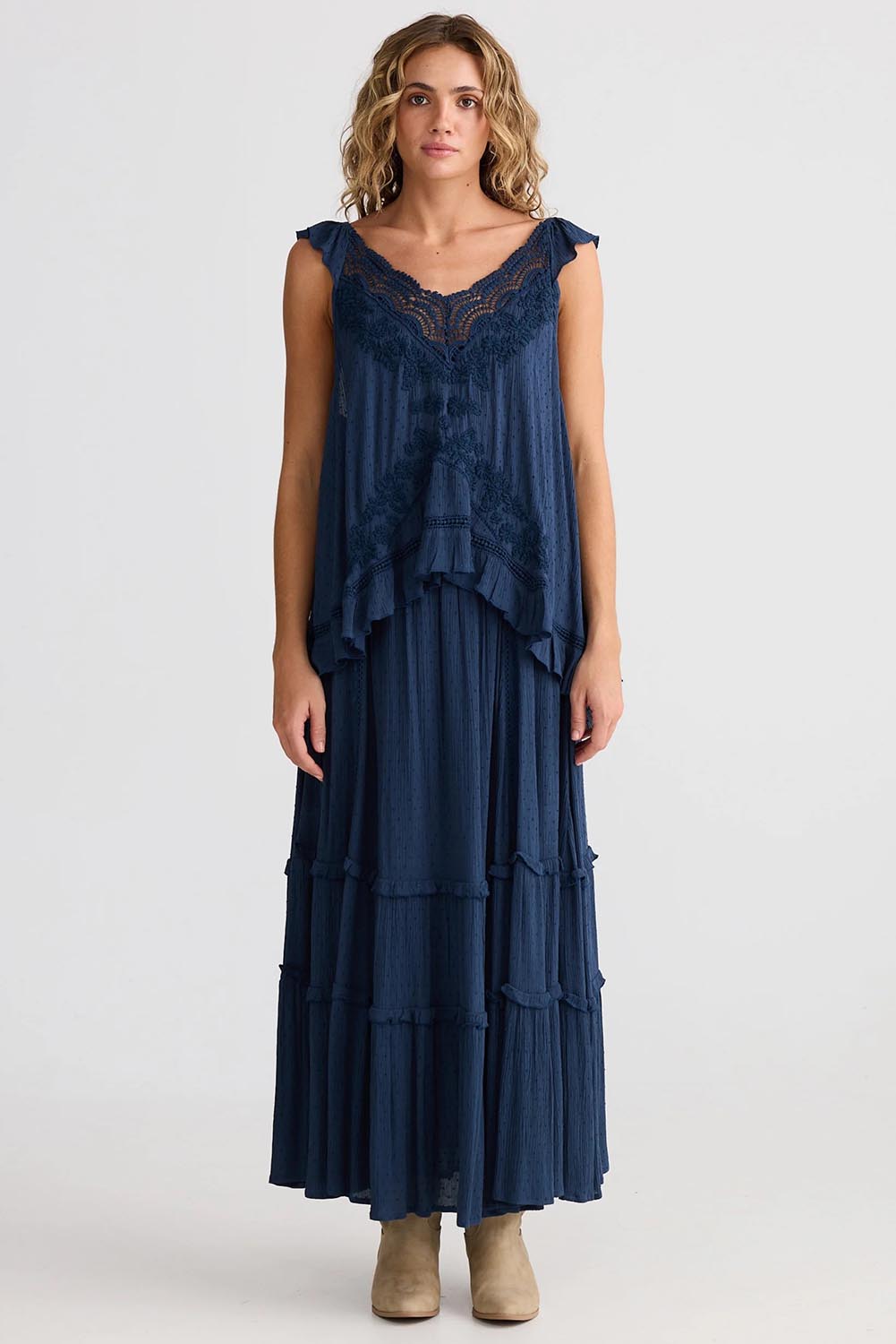 A model wearing the Exhale Cami in colour Navy (Blue), from the front, showing the whole outfit