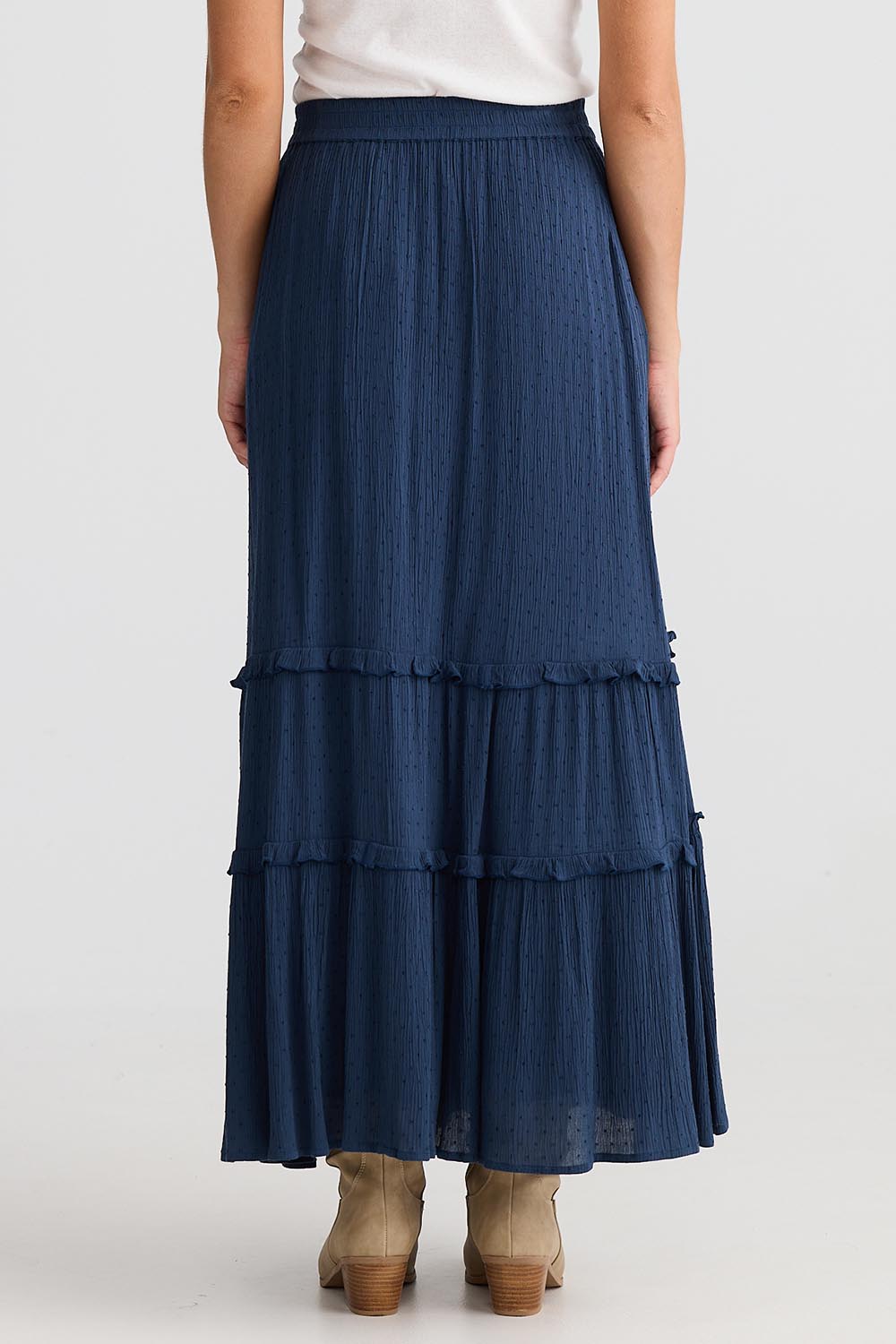 A model wearing the Inhale Maxi Skirt in colour Navy (Blue), from the back