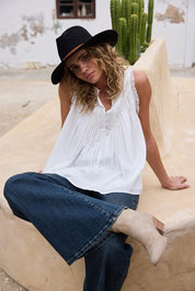 A model wearing the Sprite Cotton Sleeveless Top in colour White (White), from the front, showing the whole outfit