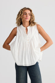 A model wearing the Sprite Cotton Sleeveless Top in colour White (White), from the front, showing the whole outfit