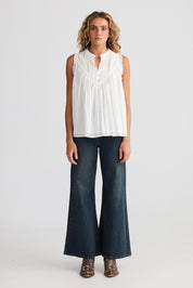A model wearing the Sprite Cotton Sleeveless Top in colour White (White), from the front, showing the whole outfit