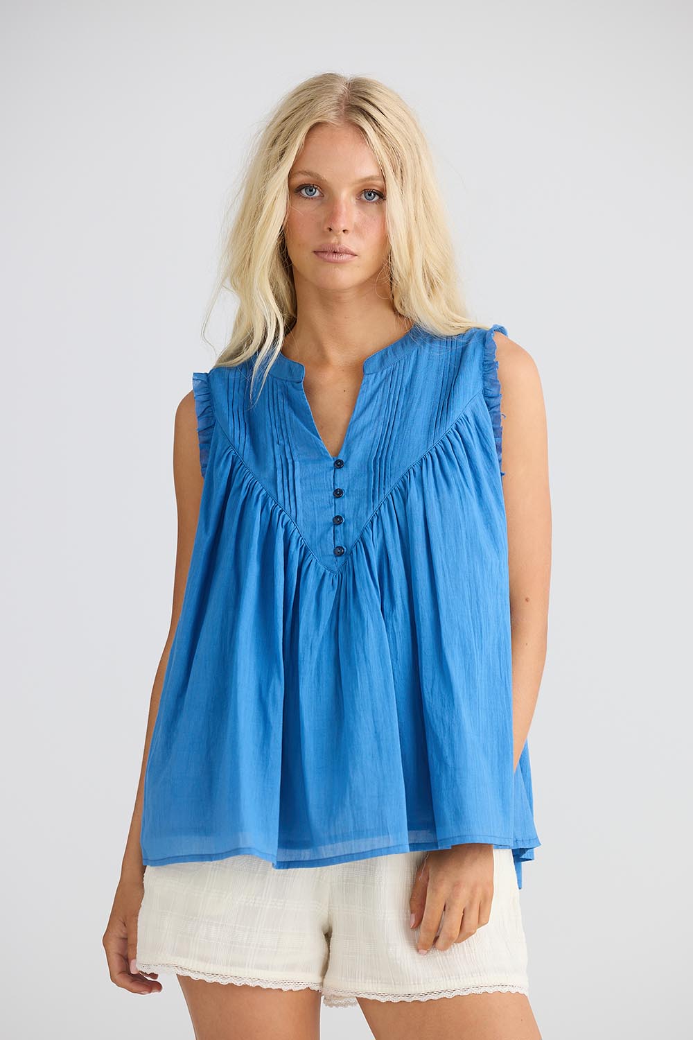 A model wearing the Sprite Cotton Sleeveless Top in colour Blue (Blue), from the front, cropped image