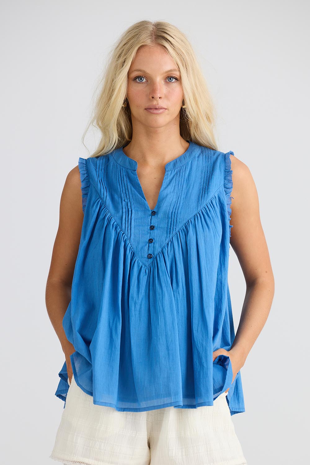 A model wearing the Sprite Cotton Sleeveless Top in colour Blue (Blue), from the front, cropped image